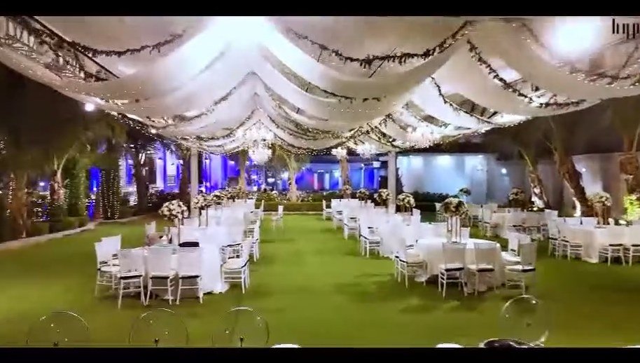 Wedding celebration — draped canopy and table setting at night